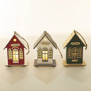Three LED wooden Christmas house ornaments in red, white, and green with warm lights
