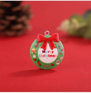 Macro detail of resin Christmas wreath pendant with bow and Merry Christmas text