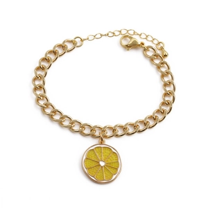 Gold chain bracelet featuring a yellow enamel lemon slice pendant with lobster clasp closure