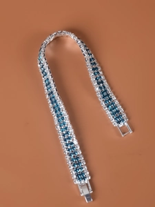 Detailed view of silver bracelet featuring blue and clear rhinestones with secure clasp