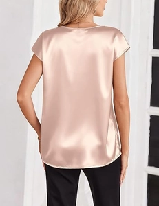 Detalle de blusa de satén champán con espalda en V y textura de seda suave y lisa