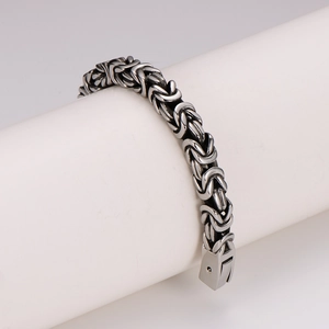 Men's silver byzantine woven stainless steel bracelet with square clasp on white stand
