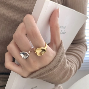 Macro shot of S925 sterling silver rings with irregular concave design in gold and silver