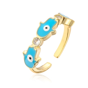 Detail of 18K gold plated Hamsa hand ring with blue evil eye enamel and cubic zirconia