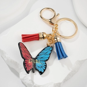 Fashion butterfly keychain with red blue pendant and colorful tassels on stone base