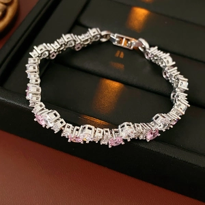Close-up of pink and white cubic zirconia tennis bracelet on black jewelry display stand