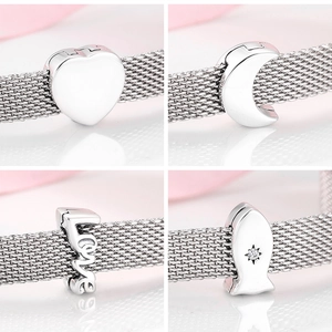 Macro detail of S925 sterling silver heart, moon, and star charms for mesh bracelets