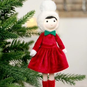 Nordic Christmas girl doll pendant in red velvet dress hanging on a festive tree