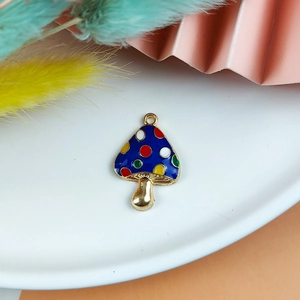 Detail of blue alloy mushroom charm with colorful polka dots for jewelry making
