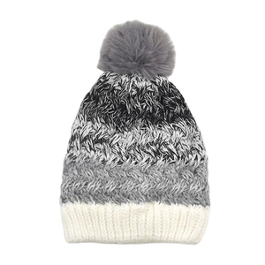 Detail of kids knit hat with grey faux fur pompom and three-color gradient design