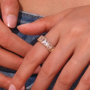 Close-up of 18K gold plated ring featuring a row of square 4A cubic zirconia stones