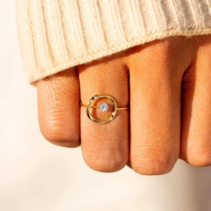 Minimalist s925 silver ring in 18K gold finish with sparkling zircon on model finger