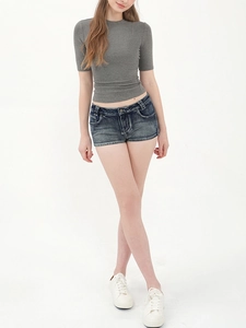 Slim fit grey knitted short sleeve top paired with dark blue denim shorts on white background