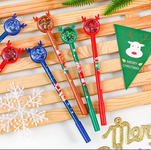 Close-up of Christmas reindeer pens with colorful sequins and festive deer horn caps