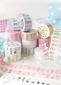 Close-up of decorative washi tape rolls featuring cute hand-drawn illustrations and pastel colors