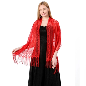 Detail of red hollow lace shawl with fringe and delicate floral crochet texture