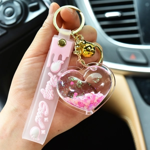 Creative pink liquid quicksand heart keychain with golden bell and silicone strap charm