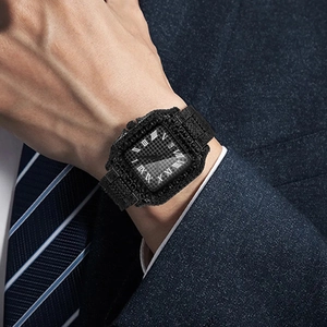 Close-up of luxury full-diamond square watch with Roman numerals on business suit sleeve