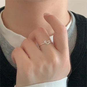 Close-up of minimalist 925 sterling silver heart ring worn on a finger