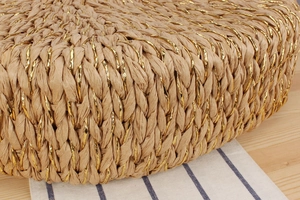 Macro shot of gold-threaded paper rope texture on a bohemian beach tote handbag