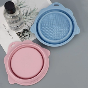 Foldable silicone makeup brush cleaning bowl set in pink and blue with multi-texture bottom