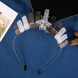 Detail of white and gray raw crystal crown headband with a silver metal bee ornament