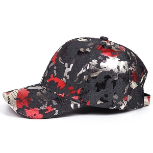 Classic camouflage baseball cap with red and grey ink splatter print on a black base