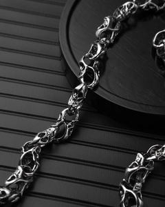 Close-up of silver punk skull metal chain with detailed engraving and metallic luster