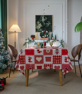 Detailed texture of Christmas plaid tablecloth with festive tree and stocking patterns