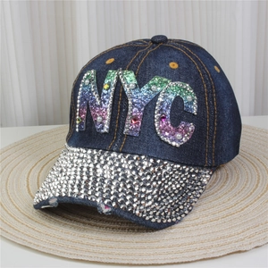 Detail of NYC rhinestone lettering and sparkling crystals on navy denim baseball cap
