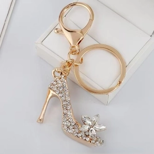 Sparkling crystal high heel keychain with floral rhinestone accent on a gift box