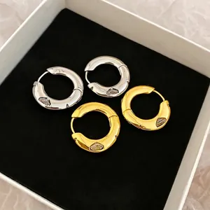 Minimalist gold and silver plated hoop earrings with marquise zircon in a jewelry box