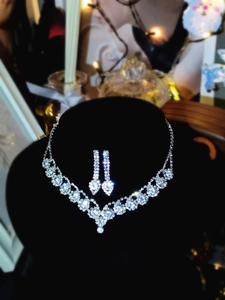 Close-up of luxury bridal jewelry set with sparkling floral zirconia on black velvet
