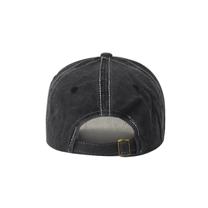 Detail view of washed cotton baseball cap with contrast stitching and metal buckle back