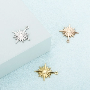 Star-shaped stainless steel charms in silver, gold, and rose gold finishes on blue background