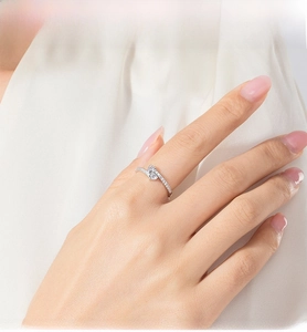 Detail of s925 silver ring featuring two interlocking hearts with shimmering zircons