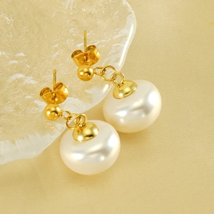 Elegant gold stainless steel stud earrings featuring large white lustrous pearl drops