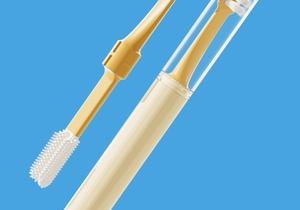 Close-up of dual-sided silicone pet toothbrush head and transparent storage case