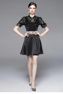 Close-up of elegant black lace dress featuring a luxury pearl belt and high waist detail