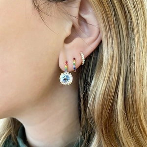 Close-up of luxury S925 sterling silver hoop earrings with colorful diamonds on ear