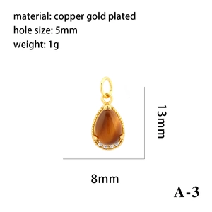 Macro detail of teardrop 18K gold plated pendant with brown opal and zircon accents