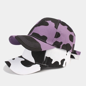 Classic cow print baseball caps in purple and white canvas with curved brims