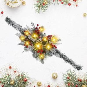 Detail of Christmas garland with red berries, pine cones and warm glowing LED lights