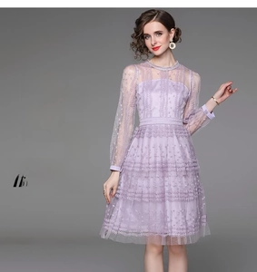 Close-up of light purple tiered lace dress featuring mesh long sleeves and round neck