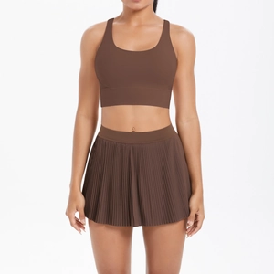 Women's brown sports bra and pleated tennis skirt set for running and yoga training