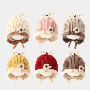 Cozy baby knit earflap hats with floral details and bows in six assorted warm colors