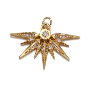 Golden sunburst pendant with sparkling zircon gemstones on a white background