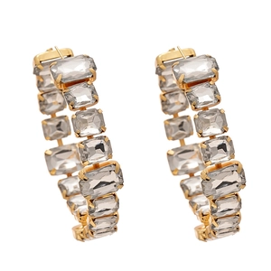 Exaggerated golden C-shape hoop earrings with rectangular crystals in a vintage luxury style