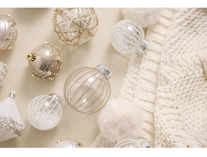 Detailed view of champagne and white Christmas balls with glitter and beaded textures
