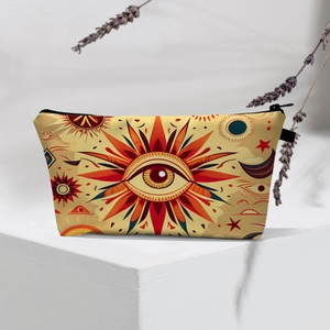 Detail of red evil eye pattern on beige fabric cosmetic bag with black zipper closure